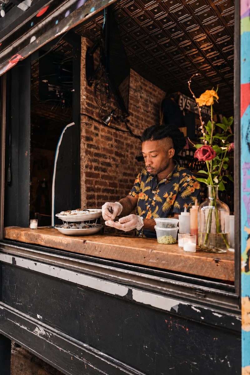 A cook preparing food at a counter window